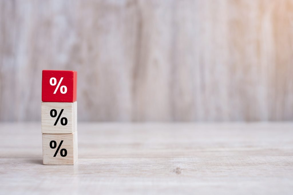 wood cube block with percentage symbol icon. Interest rate, financial, ranking and mortgage rates